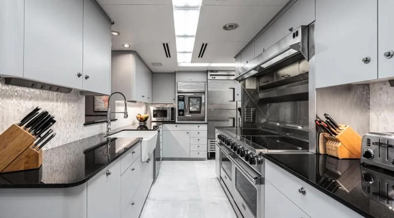 a kitchen with white cabinets aboard SCORPIO Yacht for Sale