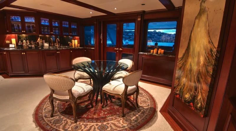 a room with a table and chairs aboard SCORPIO Yacht for Sale