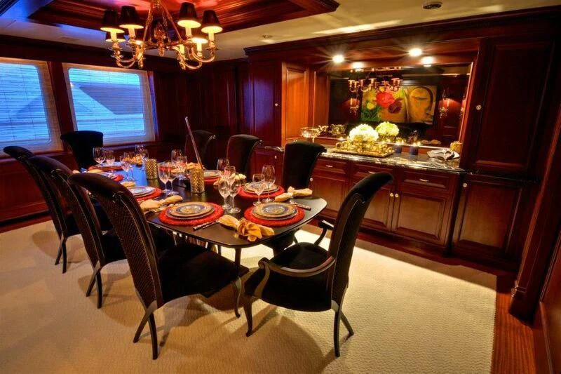 a dining room with a table and chairs aboard SCORPIO Yacht for Sale
