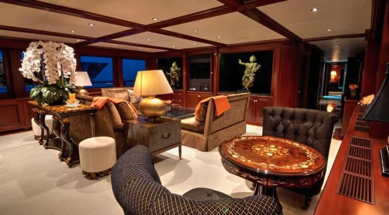 a living room with a large leather couch and a large table aboard SCORPIO Yacht for Sale