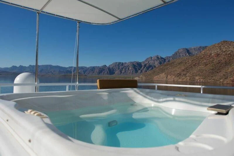 a pool with a mountain in the background aboard SCORPIO Yacht for Sale