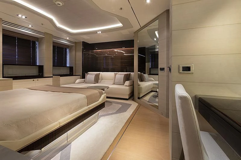 a room with a bed and a couch aboard ILLUSION Yacht for Sale