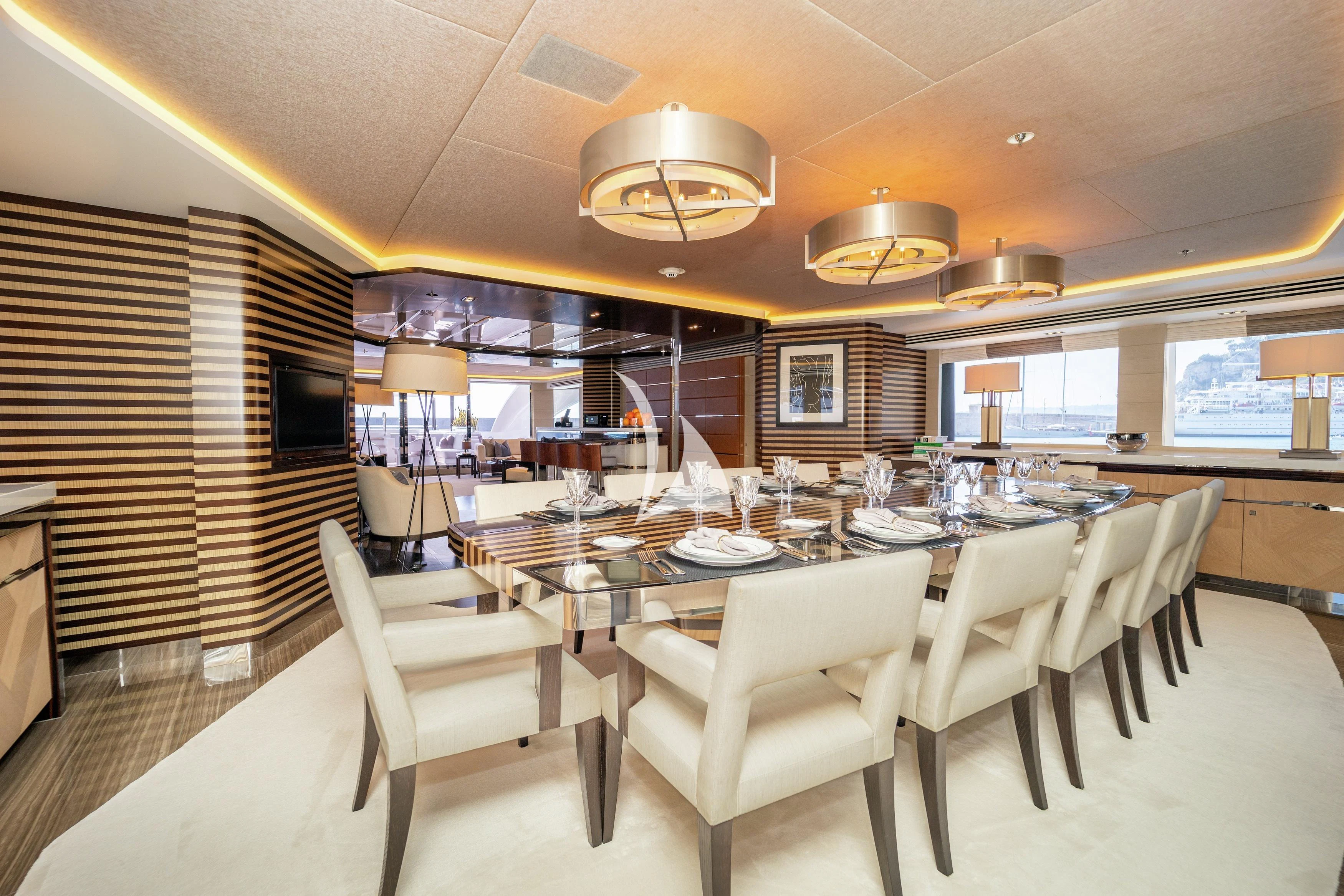 a large dining room with a large table and chairs aboard ILLUSION Yacht for Sale