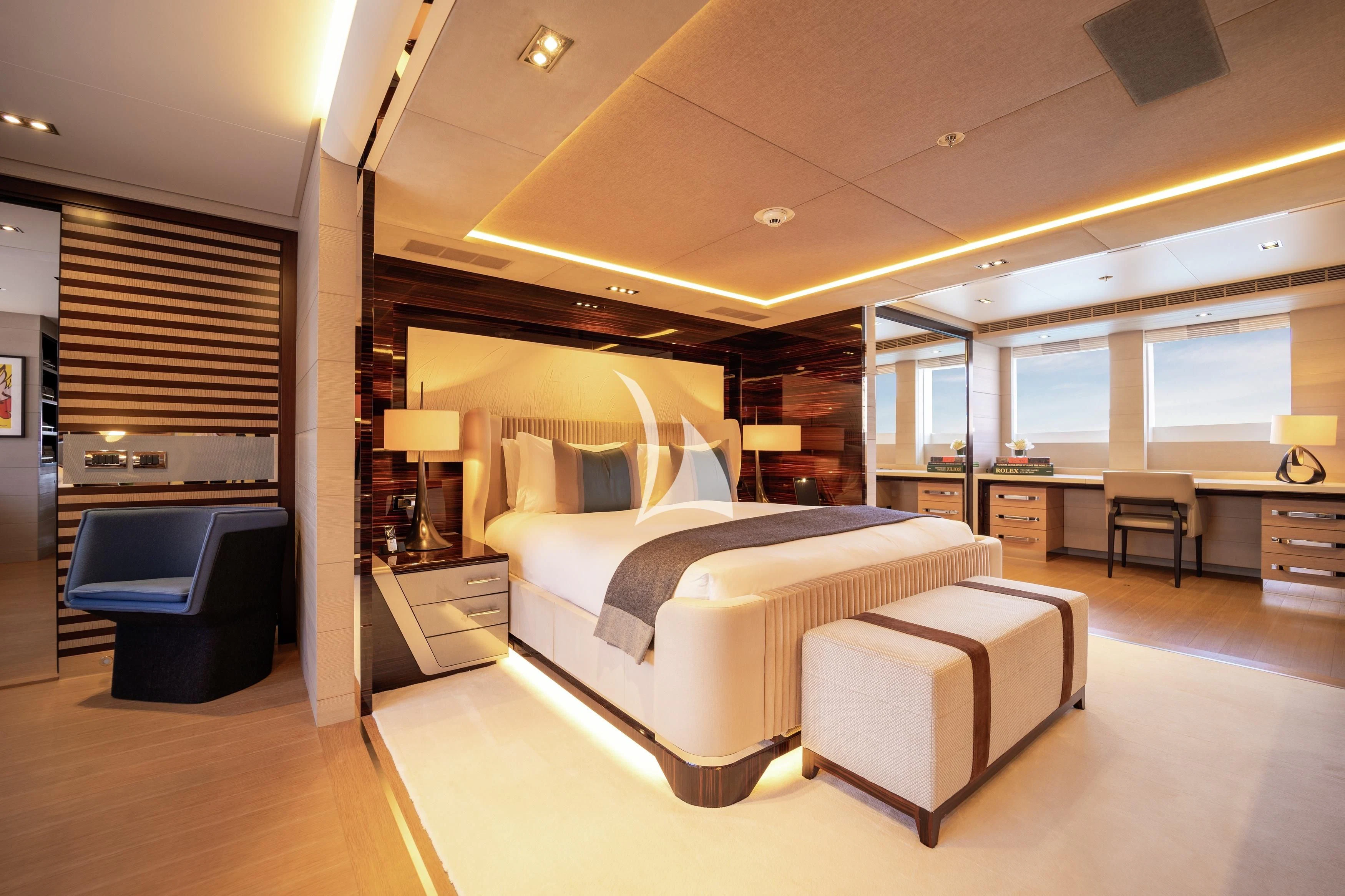 a bedroom with a bed and a desk aboard ILLUSION Yacht for Sale