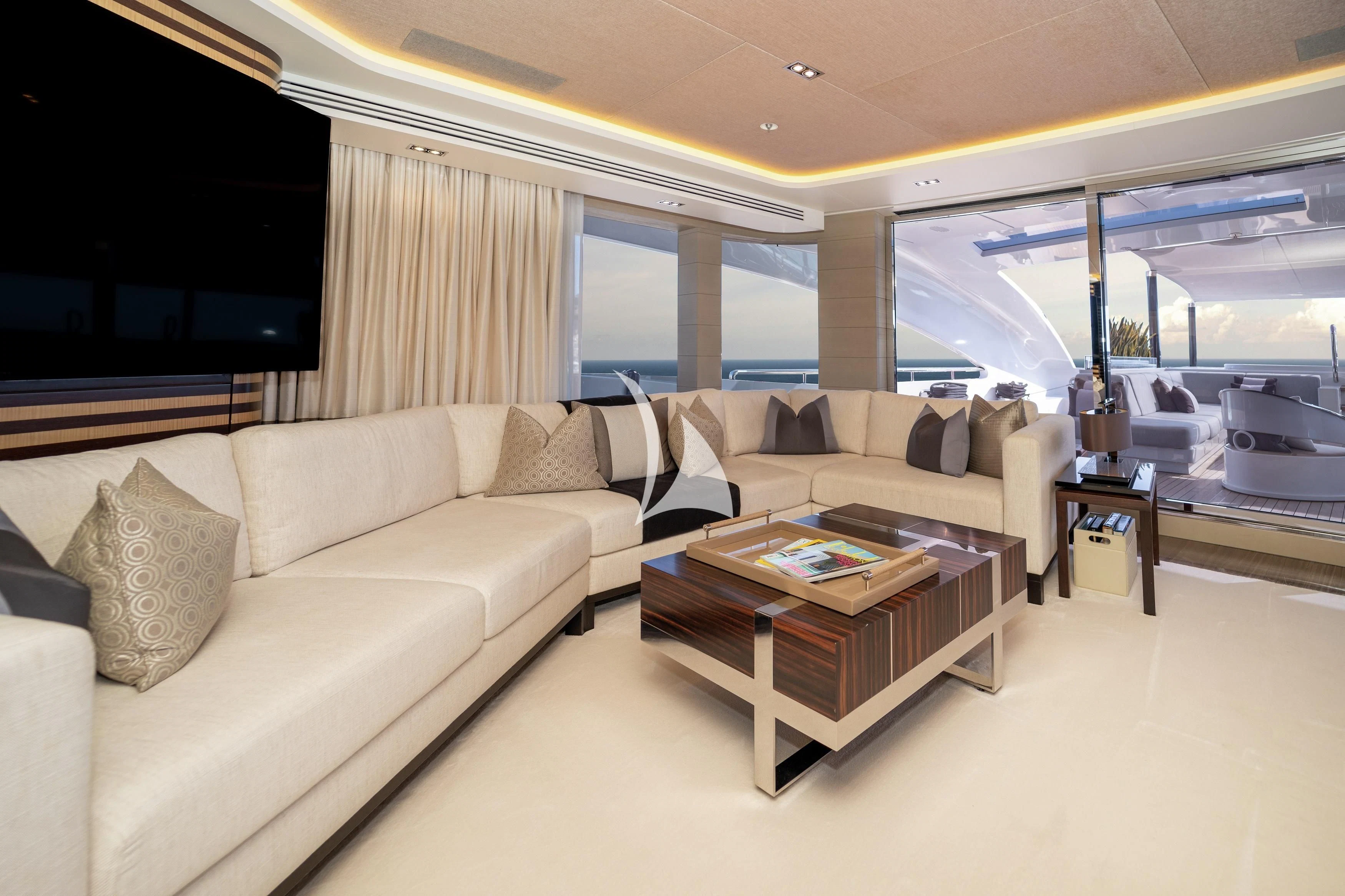 a living room with a couch and a coffee table aboard ILLUSION Yacht for Sale