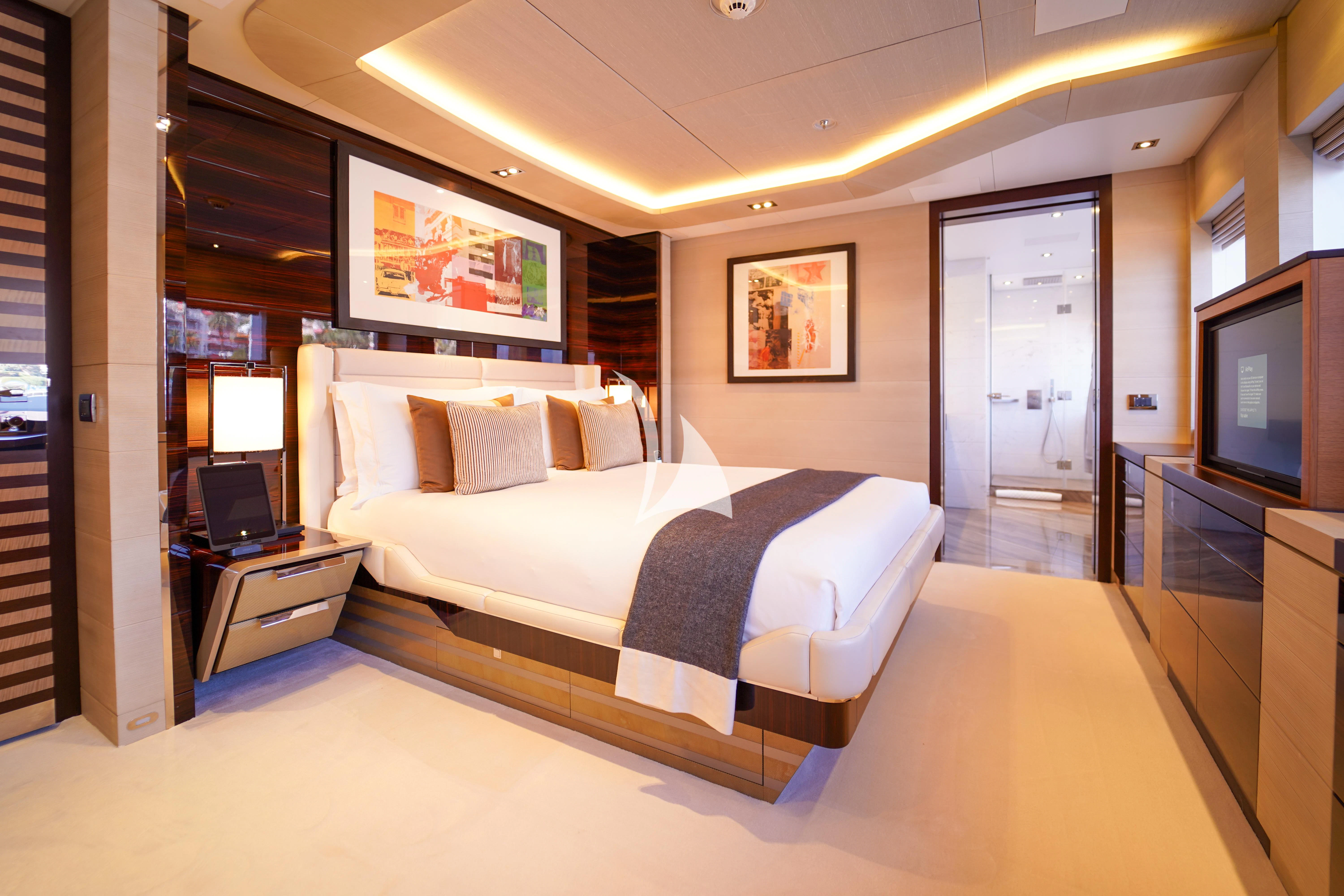 a large bedroom with a large bed aboard ILLUSION Yacht for Sale