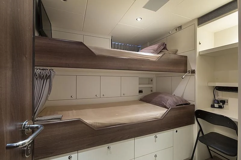 a bed with a wooden frame aboard ILLUSION Yacht for Sale