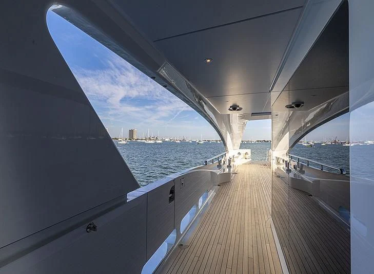 a deck with a view of the water and a city aboard ILLUSION Yacht for Sale