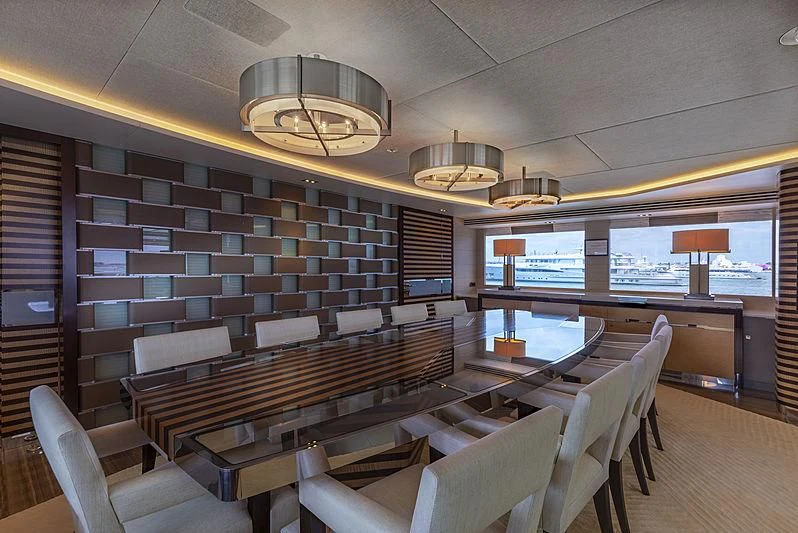 a room with a table chairs and a large window aboard ILLUSION Yacht for Sale