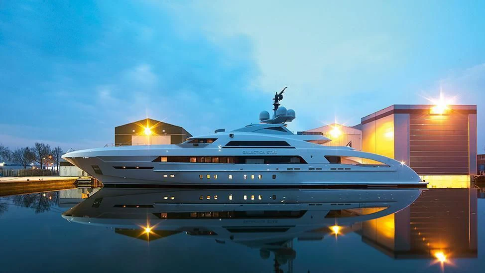 a large white yacht in a harbor aboard ILLUSION Yacht for Sale
