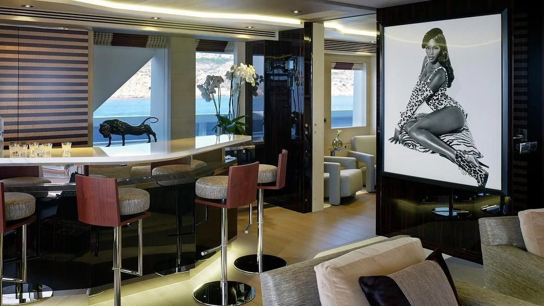 a room with a large painting on the wall aboard ILLUSION Yacht for Sale