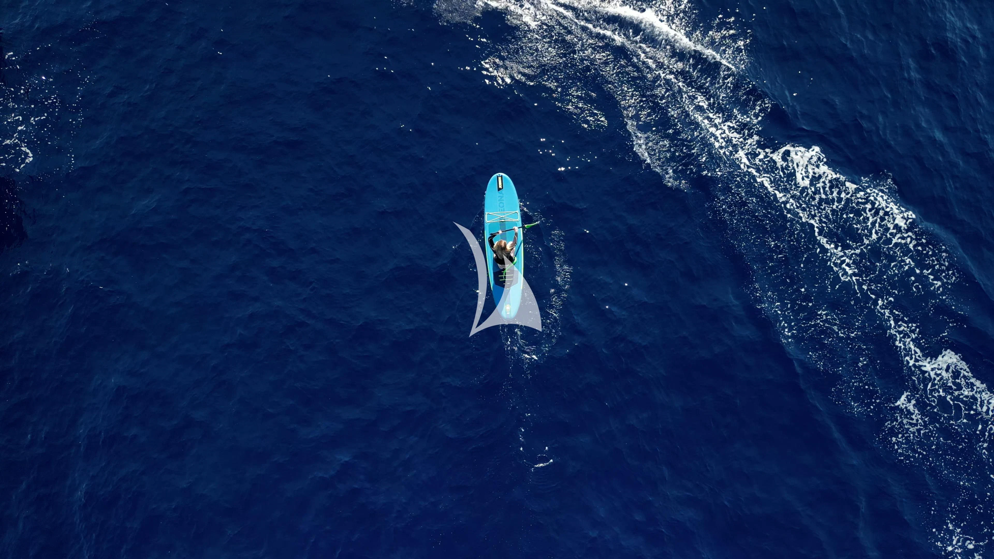 a person on a surfboard aboard ILLUSION Yacht for Sale