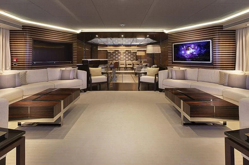 a living room with a large screen aboard ILLUSION Yacht for Sale