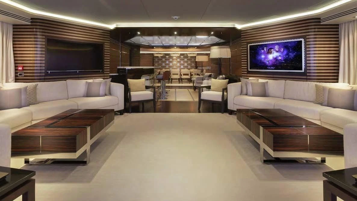 a large living room with a large screen aboard ILLUSION Yacht for Sale