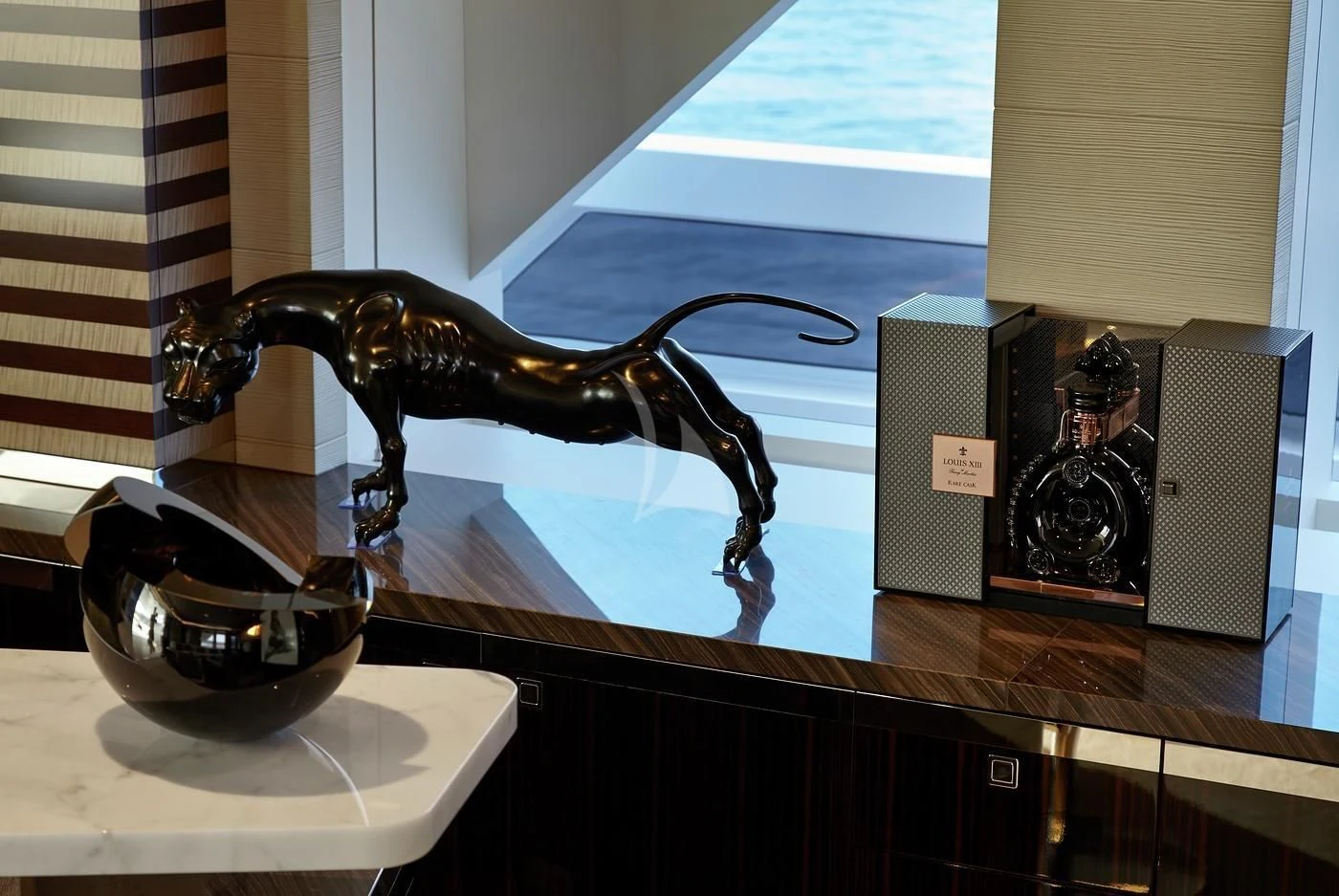 a statue of a person in a room with a mirror and a lamp aboard ILLUSION Yacht for Sale