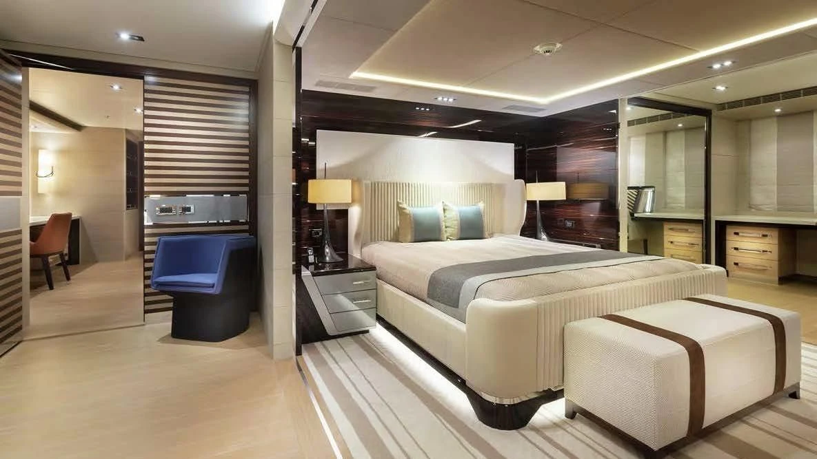 a room with a bed and a desk aboard ILLUSION Yacht for Sale