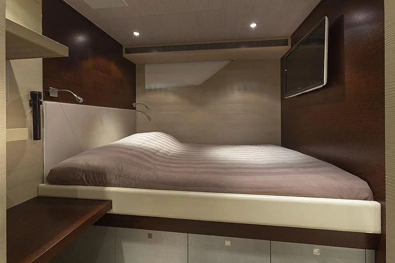 a bed with a white cover aboard ILLUSION Yacht for Sale
