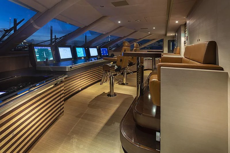 a room with a large desk and chairs and a large computer screen aboard ILLUSION Yacht for Sale