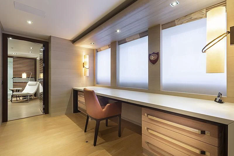 a room with a chair and a table and a window aboard ILLUSION Yacht for Sale