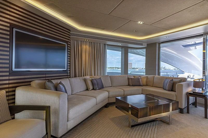 a living room with a large screen aboard ILLUSION Yacht for Sale