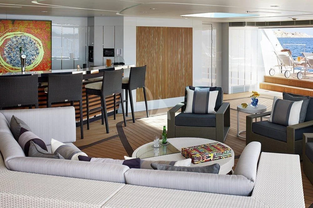 a living room with a couch and a table aboard ILLUSION Yacht for Sale