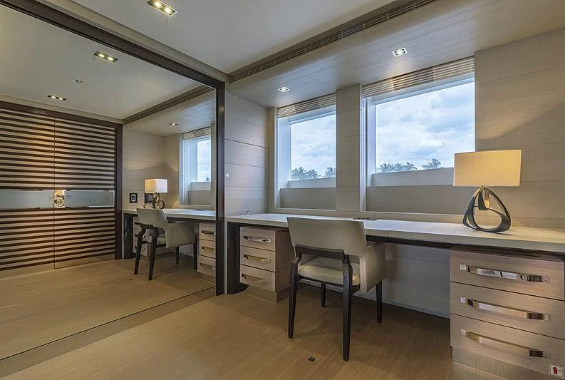 a room with a desk and a lamp aboard ILLUSION Yacht for Sale
