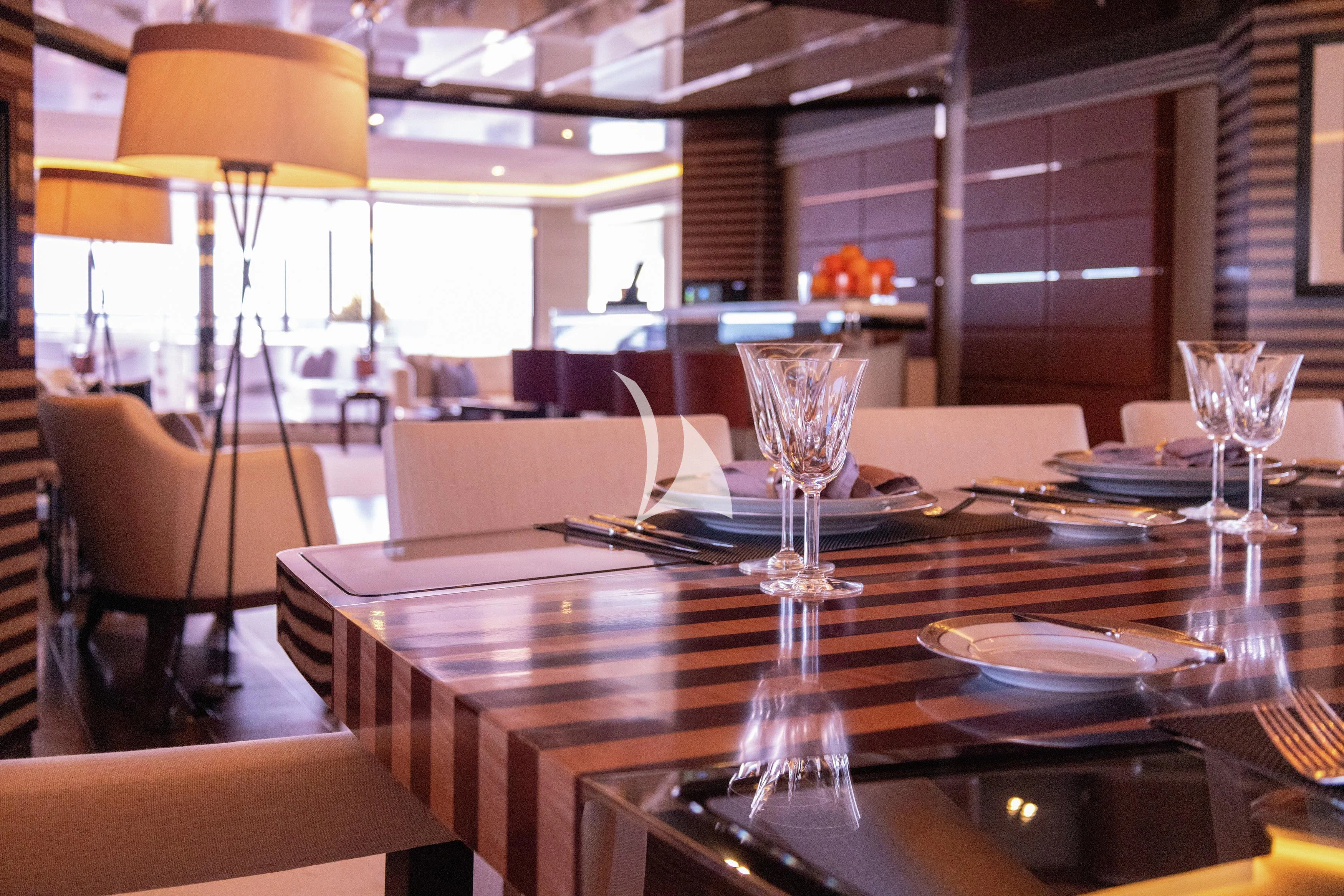 a table with plates and glasses on it aboard ILLUSION Yacht for Sale