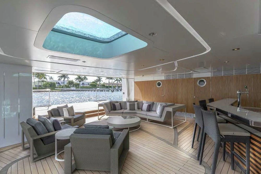 a large living room with a large open window aboard ILLUSION Yacht for Sale