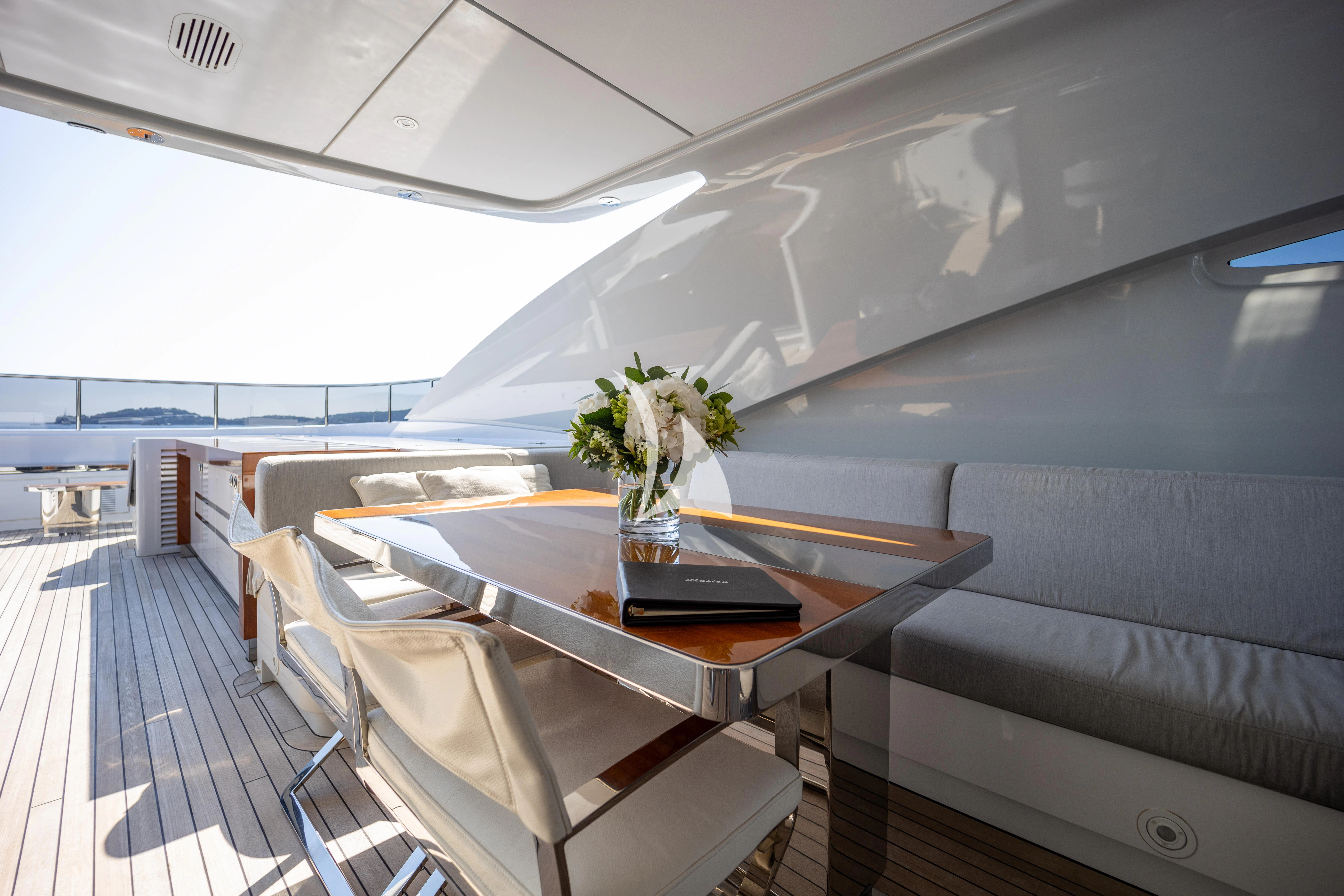 a room with a table and chairs aboard ILLUSION Yacht for Sale