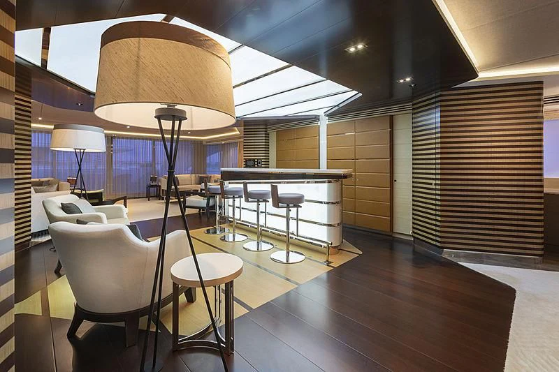 a room with tables and chairs aboard ILLUSION Yacht for Sale