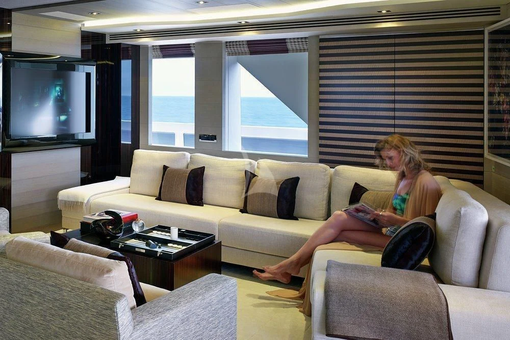 a person sitting on a couch aboard ILLUSION Yacht for Sale