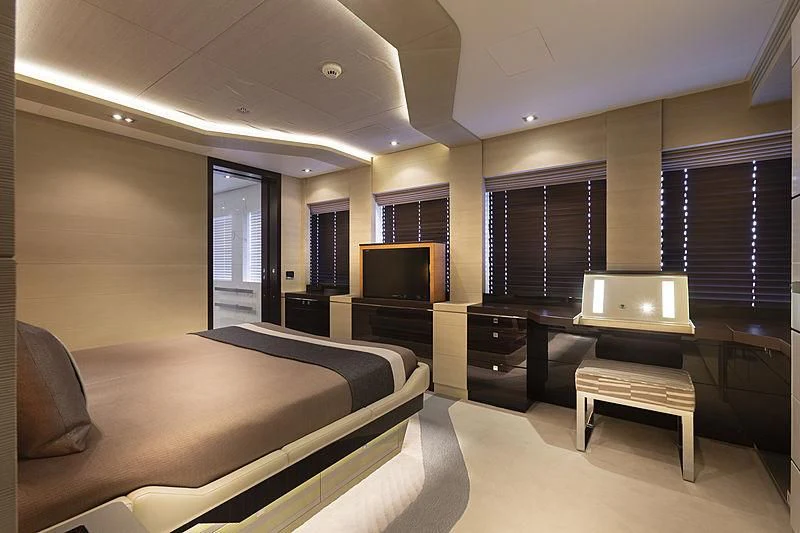 a hotel room with a tv and bed aboard ILLUSION Yacht for Sale