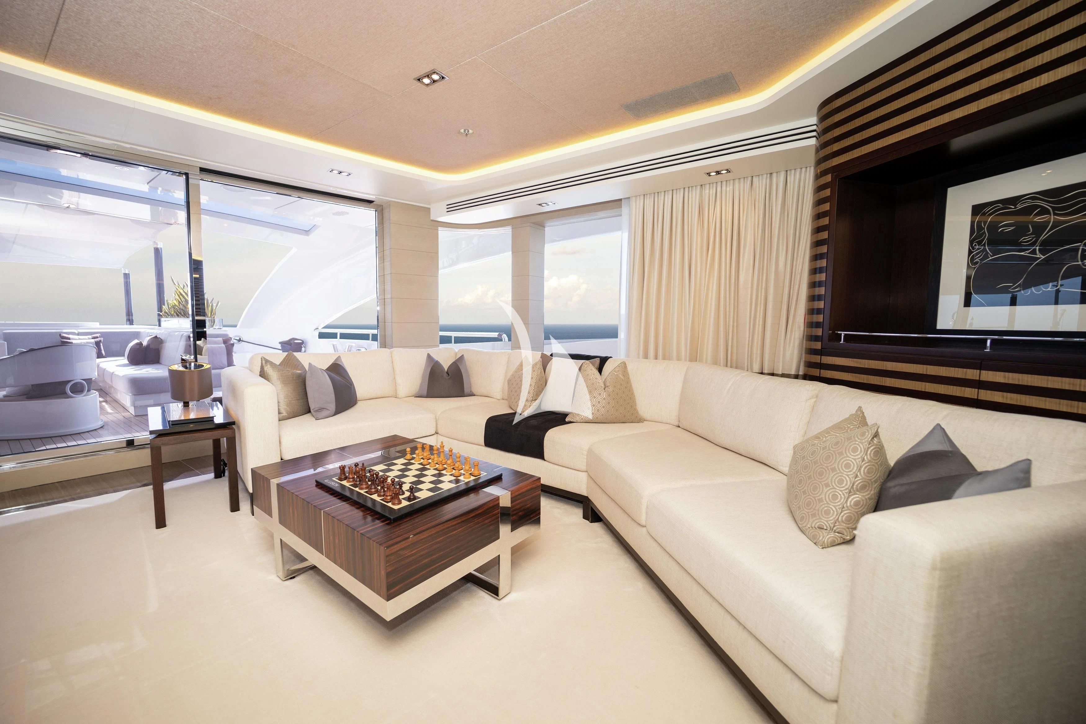 a living room with a large screen aboard ILLUSION Yacht for Sale