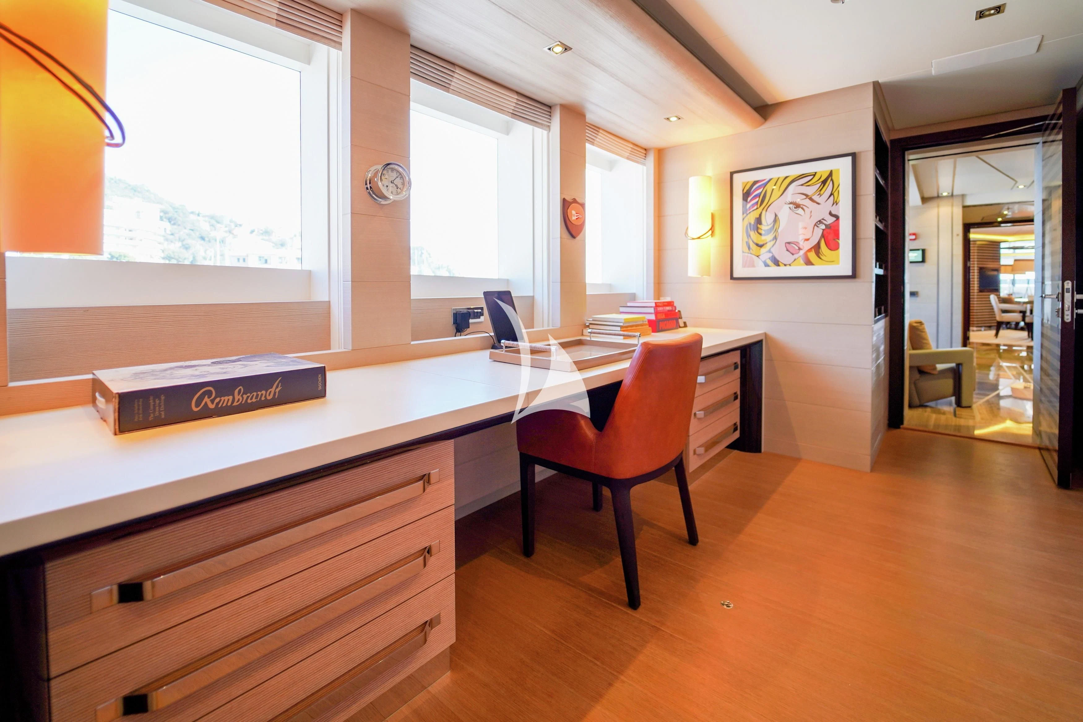 a room with a desk and a chair aboard ILLUSION Yacht for Sale