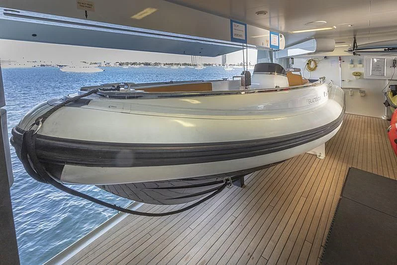 a large white boat in a large body of water aboard ILLUSION Yacht for Sale