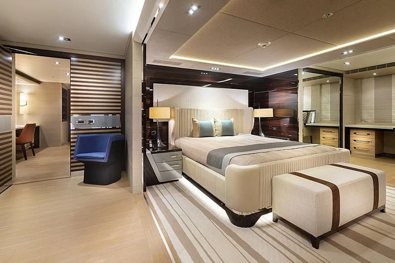 a room with a bed and a chair aboard ILLUSION Yacht for Sale