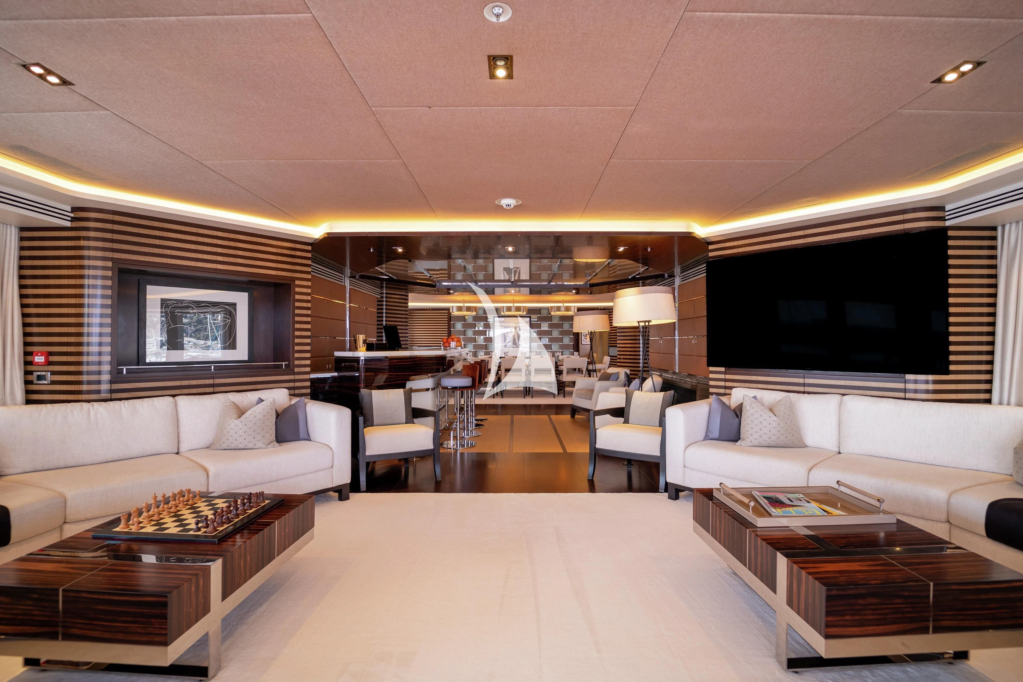a living room with a large screen aboard ILLUSION Yacht for Sale