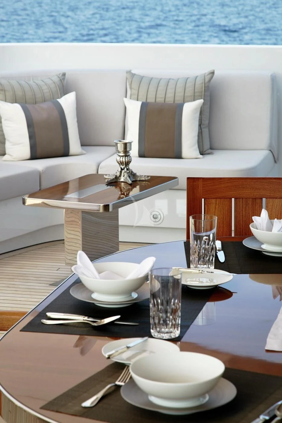 a table with a plate and a glass on it aboard ILLUSION Yacht for Sale