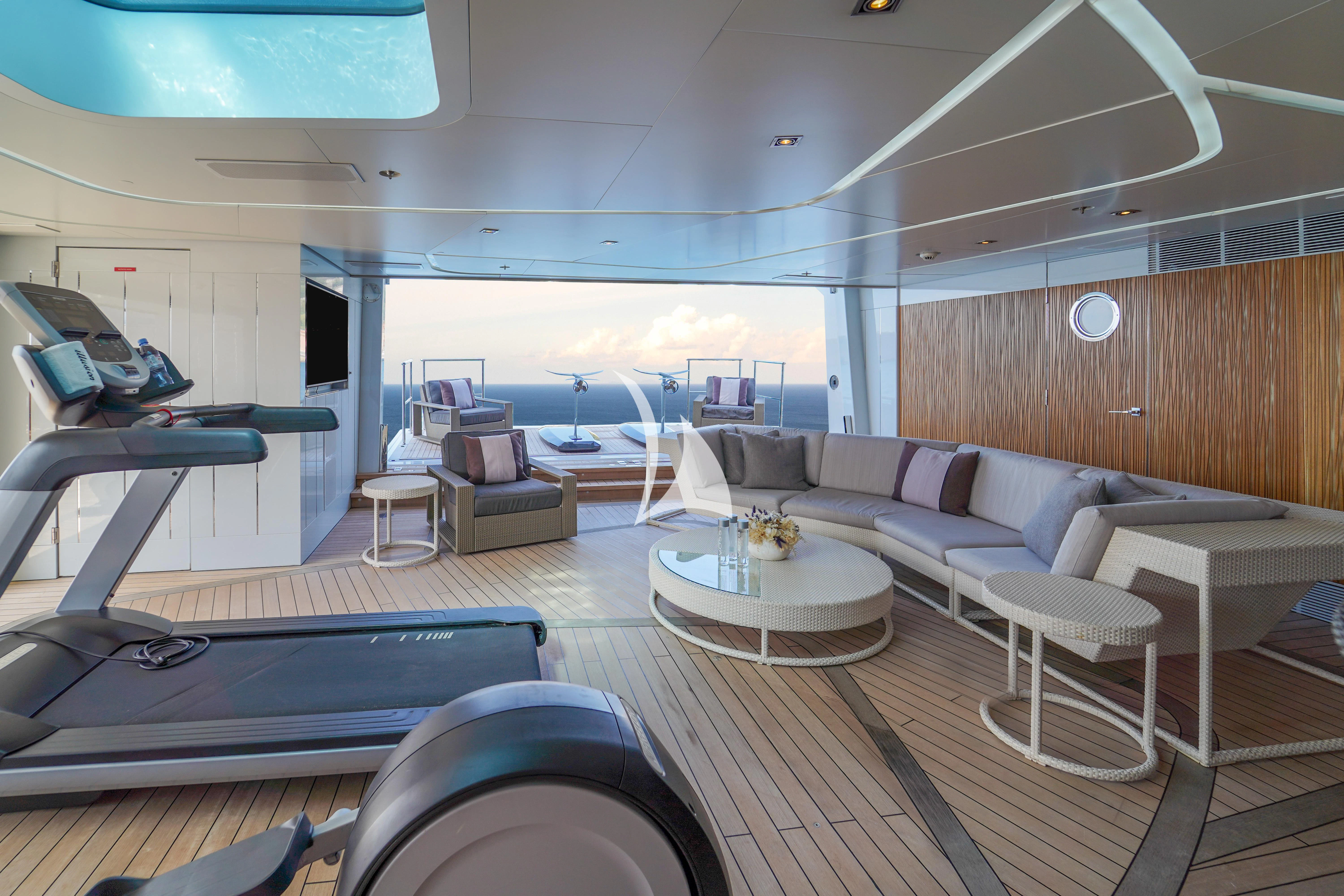 a room with a couch and a table aboard ILLUSION Yacht for Sale