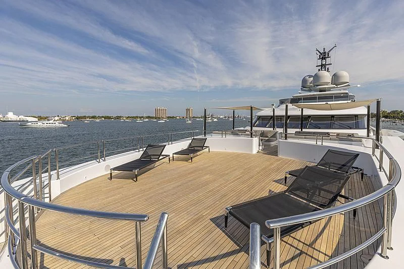 a deck with chairs and a large ship on it aboard ILLUSION Yacht for Sale
