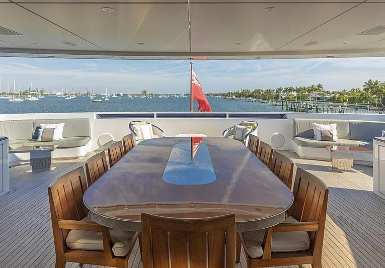 a table with chairs on it aboard ILLUSION Yacht for Sale