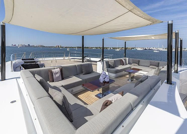 a large lounge area with a large patio and a large body of water aboard ILLUSION Yacht for Sale