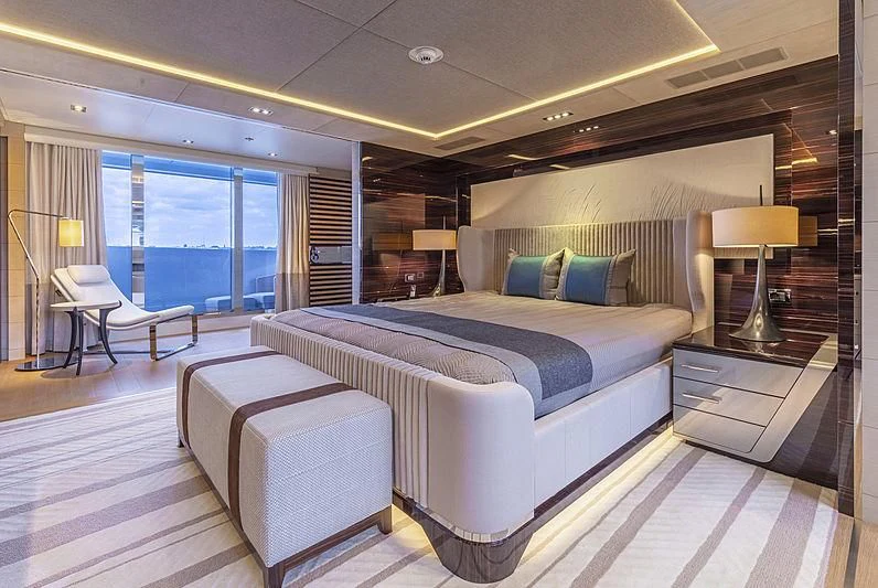 a large bedroom with a large bed aboard ILLUSION Yacht for Sale