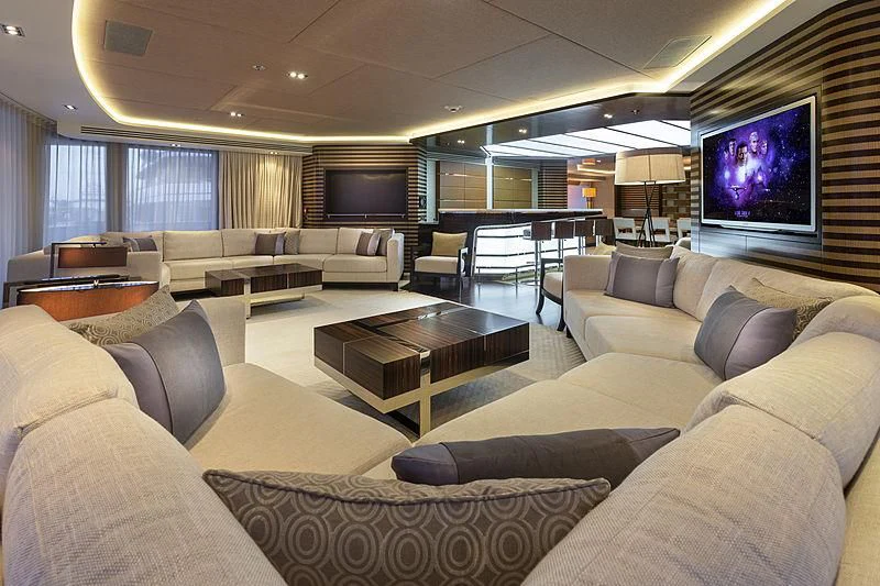 a living room with a large screen aboard ILLUSION Yacht for Sale