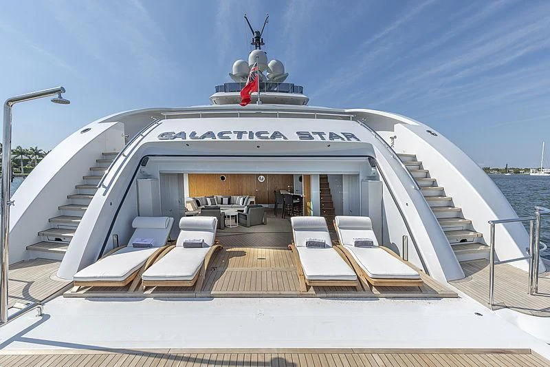 a large white boat with a desk on the deck aboard ILLUSION Yacht for Sale