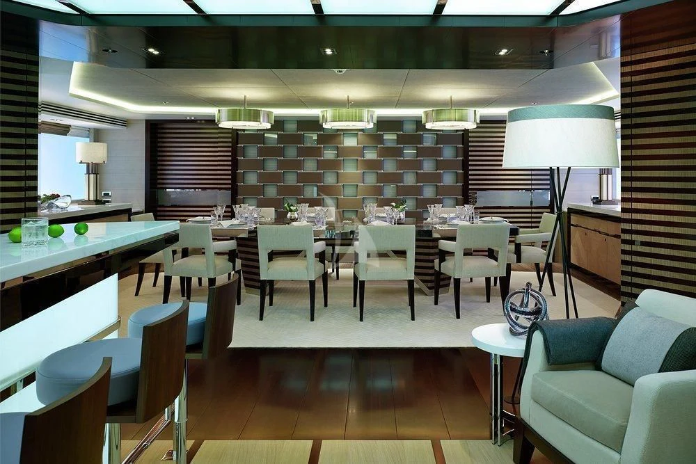 a restaurant with tables and chairs aboard ILLUSION Yacht for Sale