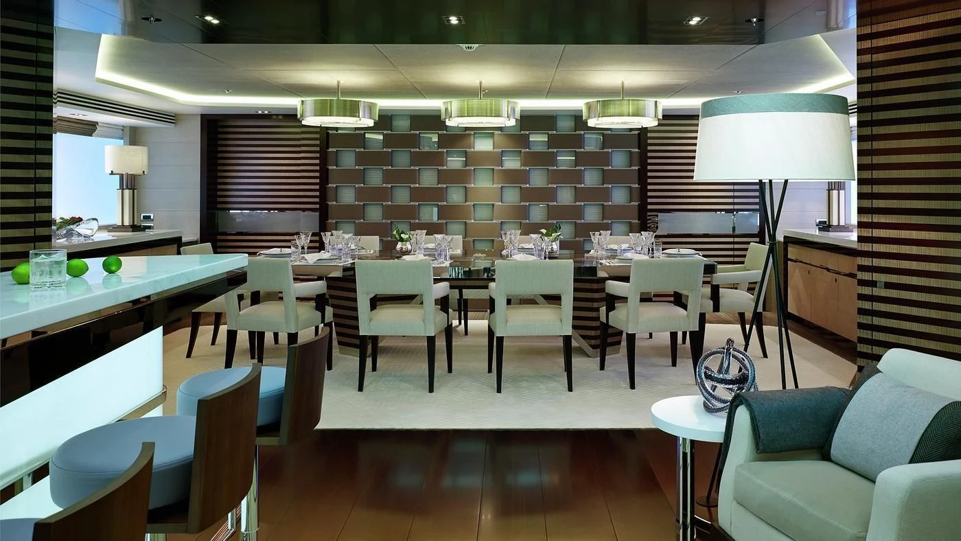 a room with tables and chairs aboard ILLUSION Yacht for Sale