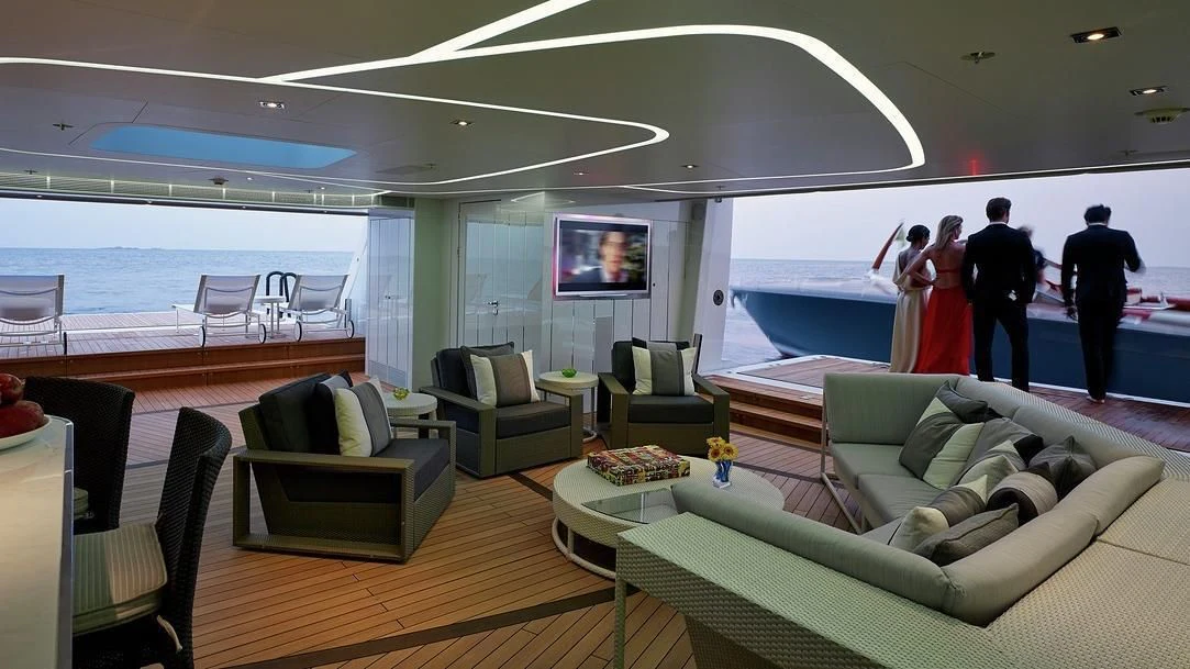 a room with a large pool and a couple of people standing in it aboard ILLUSION Yacht for Sale