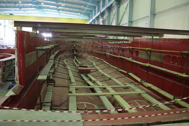 a room with a staircase and red walls aboard JEWEL Yacht for Sale