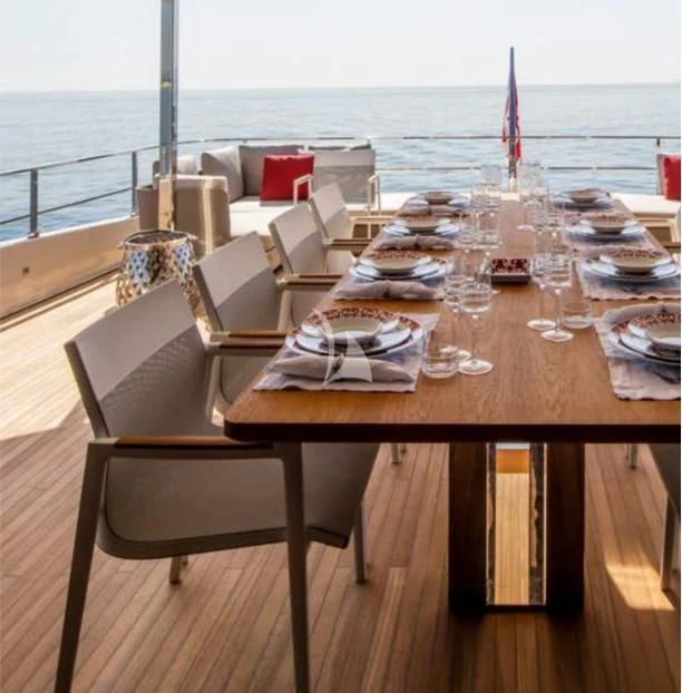 a table with chairs on it aboard ALMAX TOO Yacht for Sale